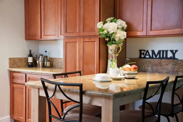 Cherry raised-panel kitchen cabinets with a granite peninsula breakfast bar