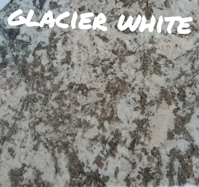Close-up of a Glacier White granite sample with grey and brown flecks